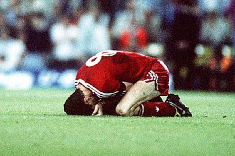 Liverpool's John Aldridge slumps on the pitch in despair after Michael Thomas scores the late title clincher for Arsenal at Anfield on May 26, 1989.