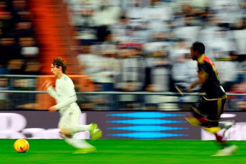Luka Modric runs with the ball during Real Madrid's match against Rayo Vallecano. AFP