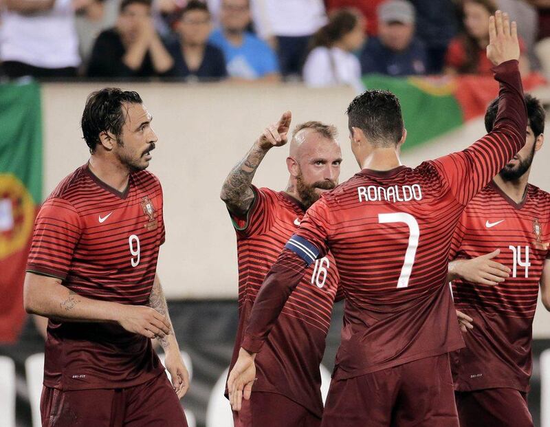 Portugal's Raul Meireles, centre, and Cristiano Ronaldo celebrate with Hugo Almeida, left, after his goal against Ireland in Tuesday night's international friendly ahead of the 2014 World Cup. Ray Stubblebine / Reuters /June 10, 2014