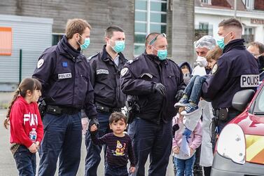 French Gendarmes and police assist migrants, including five children and a baby, who tried to reach England by crossing the Channel, and who were rescued off the French port city of Calais on May 16. Bernard Barron / AFP