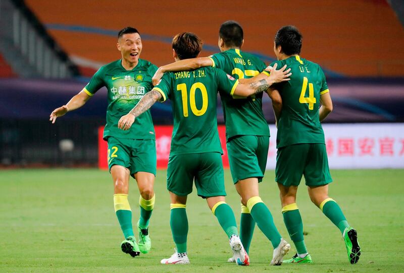 Beijing Guoan's Yu Dabao, left, celebrates with teammates during their Chinese Super League match against Shanghai SIPG in Suzhou. AFP