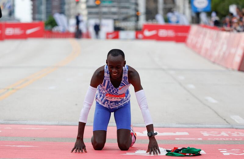 Kenya's Kelvin Kiptum drops to his knees after winning the 2023 Chicago Marathon in Chicago, Illinois. AFP