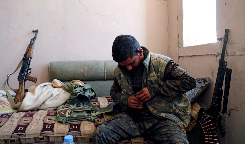 A fighter of the Syrian Democratic Forces refills his magazines with bullets for his weapon, at their positions at the frontline in Raqqa. Erik De Castro / Reuters