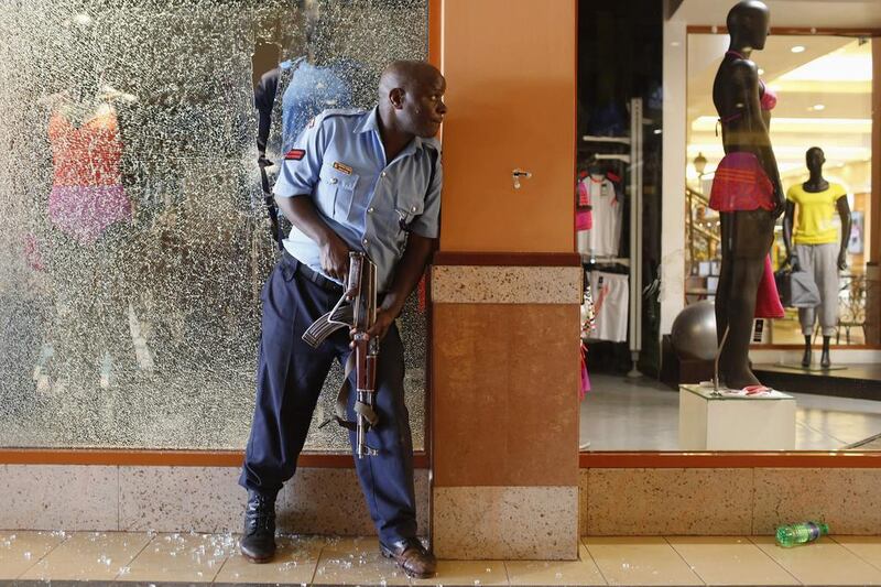 A police officer tries to secure an area inside the Westgate mall where Al Shabab gunmen went on a shooting spree. Siegfried Modola / Reuters