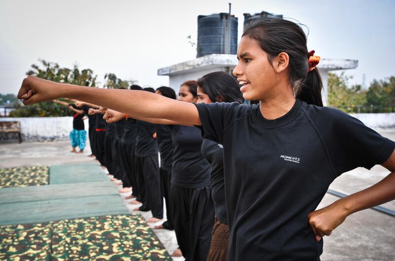 Young women from the Red Brigade take part in a martial arts training session on the roof of a building in the city of Lucknow. The Red Brigade was formed in November 2010 to fight back against a growing number of sexual attacks on women in the Madiyav area of the city of Lucknow, in Uttar Pradesh state, India.
The group of young women wear distinctive red and black salwar kameez. Most have been victims of sexual assault and have resolved that they will take no more. They take direct action against their tormentors and now when a local man steps out of line, he can expect a visit from the Red Brigade and a thrashing.