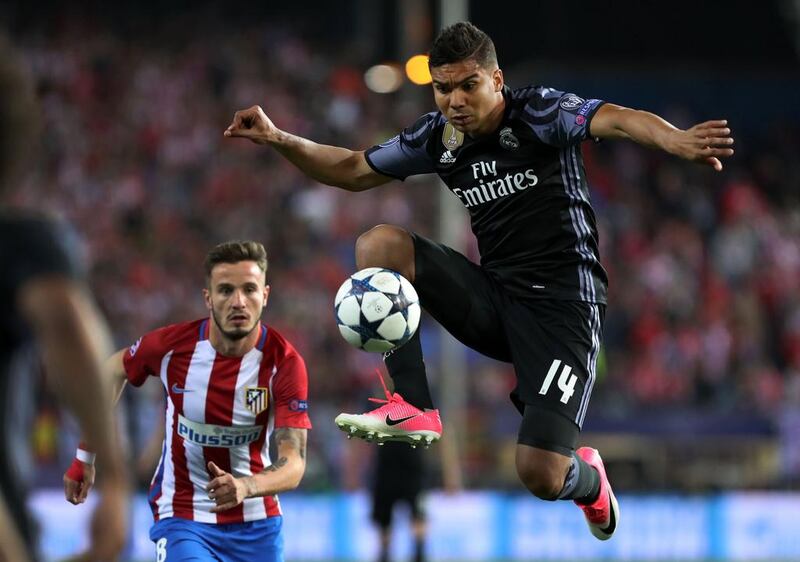 Real Madrid’s Casemiro controls the ball beside Atletico Madrid’s midfielder Saul Niguez. Cesar Manso / AFP