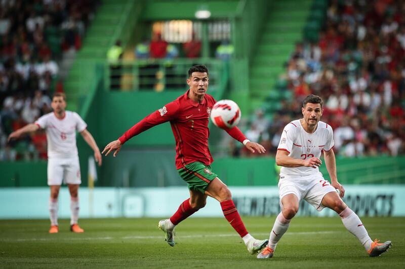 Cristiano Ronaldo in action against Switzerland's Fabian Schaer. EPA
