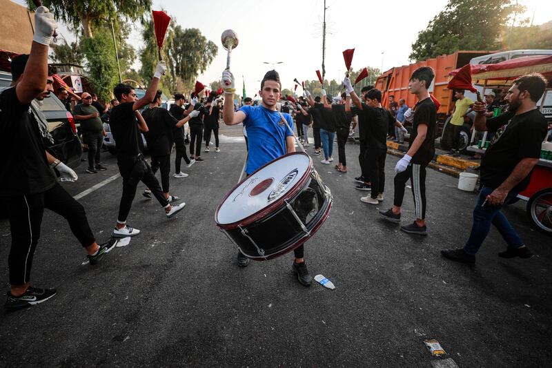 Iraqis whip themselves with chains during the Ashura commemoration period outside the Iraqi parliament, as Mr Al Sadr's supporters occupy the building for a fifth consecutive day. AFP