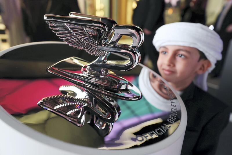 Abu Dhabi, United Arab Emirates - Reporter: Simon Wilgress-Pipe: Saeed aged 5 looks at the Bentley hood ornament. The opening of the new Bentley Emirates showroom. Tuesday, January 21st, 2020. Abu Dhabi. Chris Whiteoak / The National