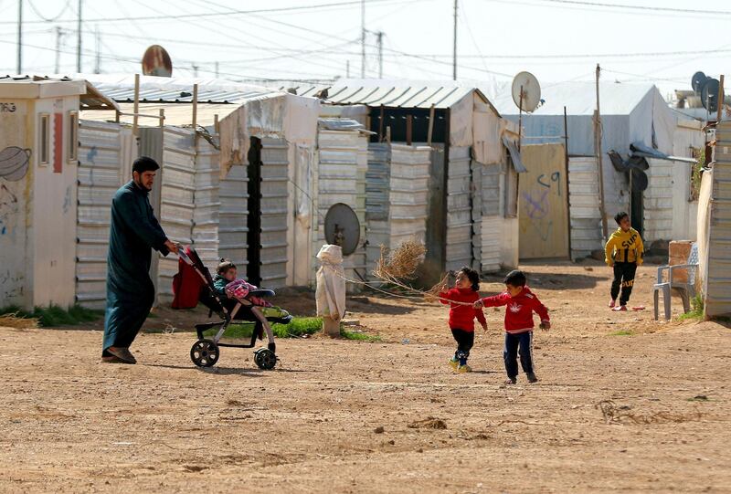 Syrian children play in the Zaatari refugee camp, 80 kilometers (50 miles) north of the Jordanian capital Amman on February 15, 2021. (Photo by Khalil MAZRAAWI / AFP)