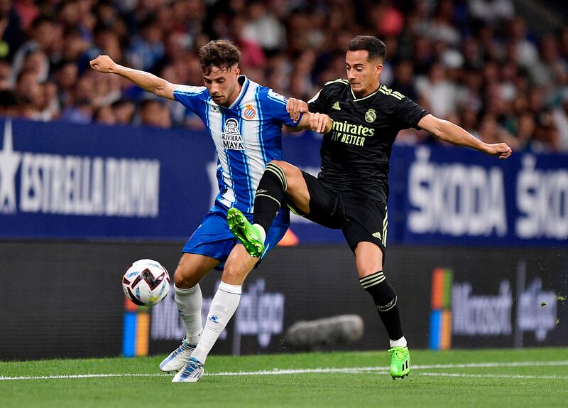 Real Madrid midfielder Lucas Vazquez challenges for the ball against Espanyol's Javi Puado. Reuters