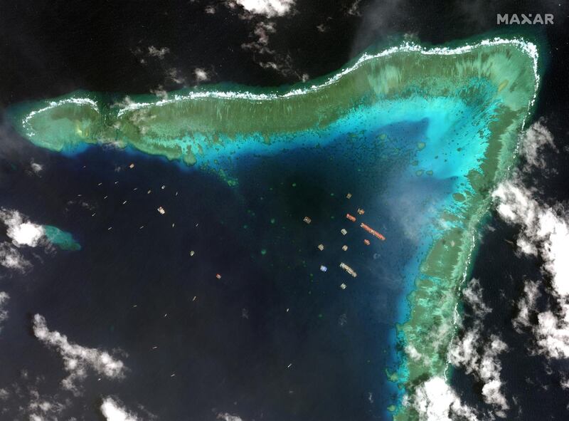 A satellite image shows Chinese vessels anchored at the Whitsun Reef in the disputed South China Sea. The Philippines government expressed grave concern at the presence of more than 200 Chinese militia boats in the Whitsun Reef area, calling it 'a clear provocative action of militarising the area'. The Chinese embassy in Manila denied the accusations saying they were fishing vessels taking shelter from rough seas.  EPA/Maxar Technologies
