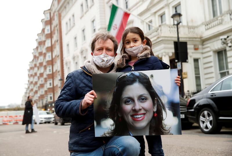 FILE PHOTO: Richard Ratcliffe, husband of British-Iranian aid worker Nazanin Zaghari-Ratcliffe, and their daughter Gabriella protest outside the Iranian Embassy in London, Britain March 8, 2021. REUTERS/Andrew Boyers/File Photo