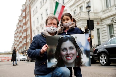 Richard Ratcliffe, with his daughter Gabriella, holds an image of his wife Nazanin Zaghari-Ratcliffe, who remains in Tehran. Reuters