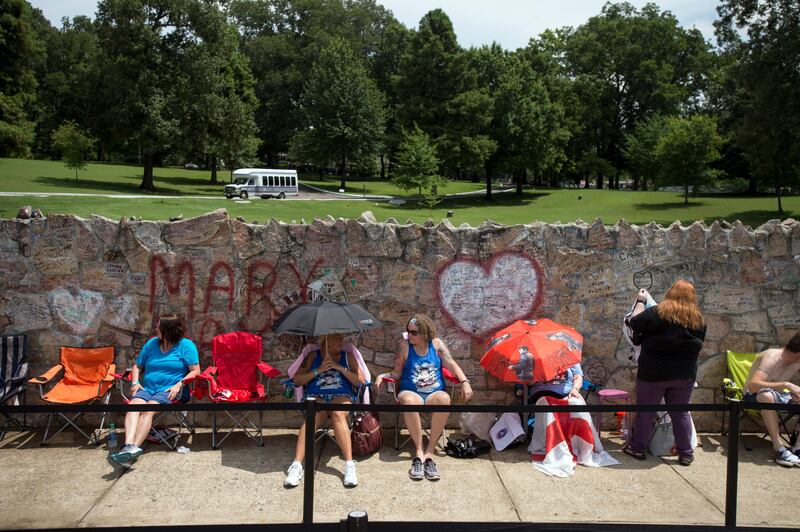 Fans wait in line outside Graceland, Elvis Presley's Memphis home. Fans from around the world are at Graceland for the 40th anniversary of his death.  Brandon Dill / AP photo