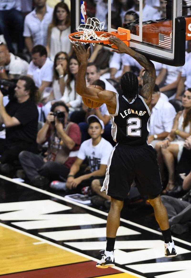 San Antonio Spurs forward Kawhi Leonard slam dunks the ball against the Miami Heat in Game 3 of the NBA Finals on Tuesday night. Larry W Smith / EPA / June 10, 2014