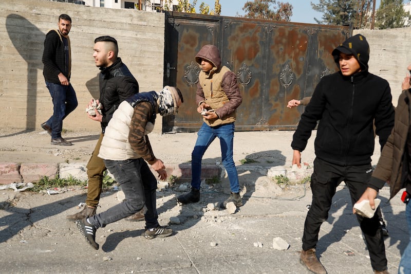 Palestinian stone-throwers gather amid the raid in Jenin. Reuters