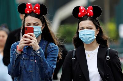 FILE PHOTO: Visitors wear protective face masks at Disneyland Paris, July 15, 2020.   REUTERS/Charles Platiau/File Photo