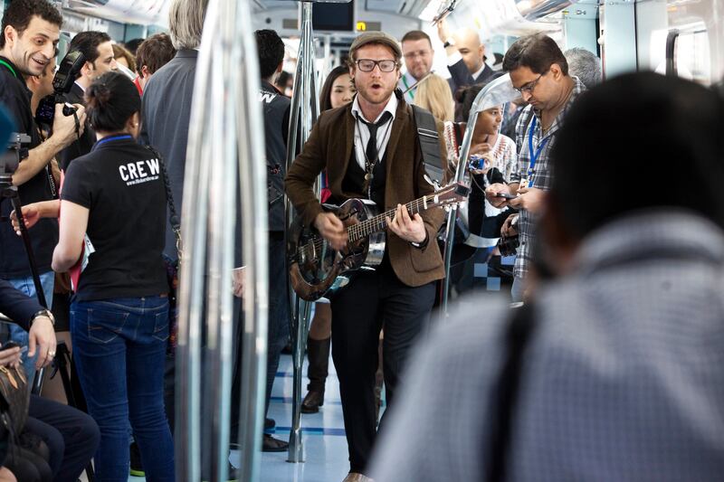 DUBAI, UNITED ARAB EMIRATES,  January 23, 2013. Tim Hassal (with guitar) and Co perform during the Fashion Train show by Dubai Shopping Festival and Bloomingdales where a fashion show was held on the Dubai Metro. (ANTONIE ROBERTSON / The National)