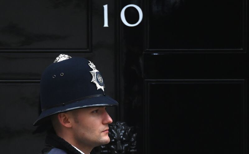 A police officer outside 10 Downing Street in London.  The Metropolitan Police have issued 20 penalty notices so far over Covid rule-breaking parties in British PM's official residence. EPA