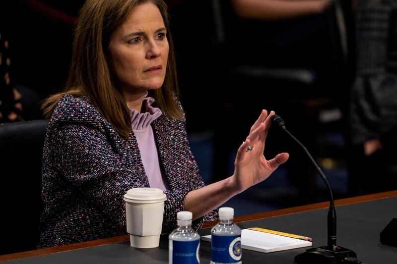 Judge Amy Coney Barrett tests her microphone after it failed several times during the third day of her Senate confirmation hearing to the Supreme Court on Capitol Hill in Washington DC, US.  Reuters