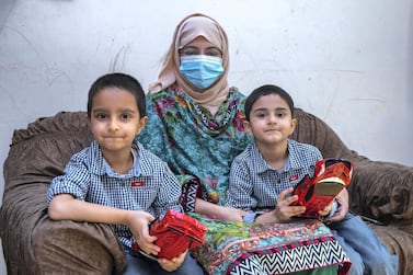 Alia Usman, widow of Muhammad Usman Khan, who died of Covid-19, with her sons, from left to right, Mohanad, 6, and Akhdan, 5. Victor Besa / The National