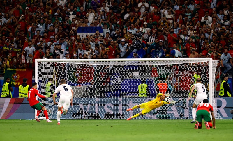 Slovenia goalkeeper Jan Oblak saves a penalty from Portugal's Cristiano Ronaldo. Reuters
