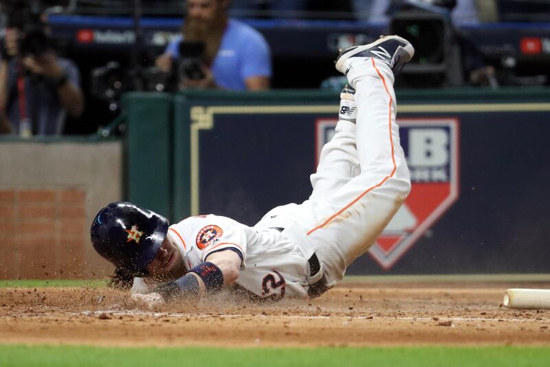 Houston Astros right fielder Josh Reddick scores a run against the Los Angeles Dodgers in the fifth inning in game three of the 2017 World Series at Minute Maid Park. Thomas B. Shea / USA TODAY Sports