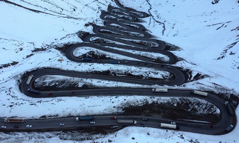 Vehicles travel along a serpentine road to cross the international land border 'Los Libertadores' between Chile and Argentina. Reuters