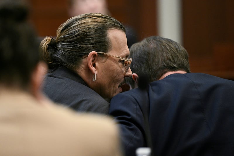 Depp speaks to his lawyer. Reuters