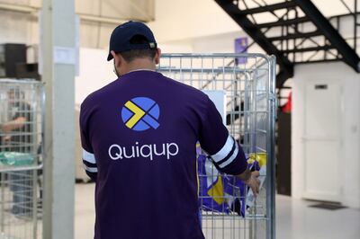 A Quiqup delivery rider collects packages from the company's Al Quoz warehouse. Pawan Singh / The National 