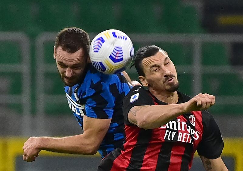 Inter Milan's Dutch defender Stefan de Vrij battles for the ball with AC Milan's Swedish forward Zlatan Ibrahimovic. AFP