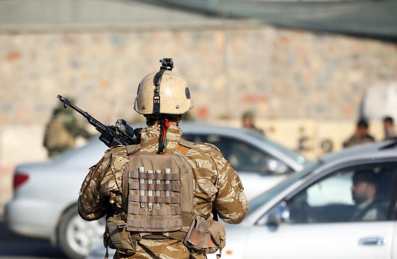 epa08005018 An Afghan National Army (ANA) officer stands guard at the scene of an attack in Kabul, Afghanistan, 18 November 2019. According to media reports, at least four soldiers were injured in back-to-back explosions outside the Kabul Military Training Center (KMTC). No group has yet claimed responsibility, media added.  EPA/JAWAD JALALI