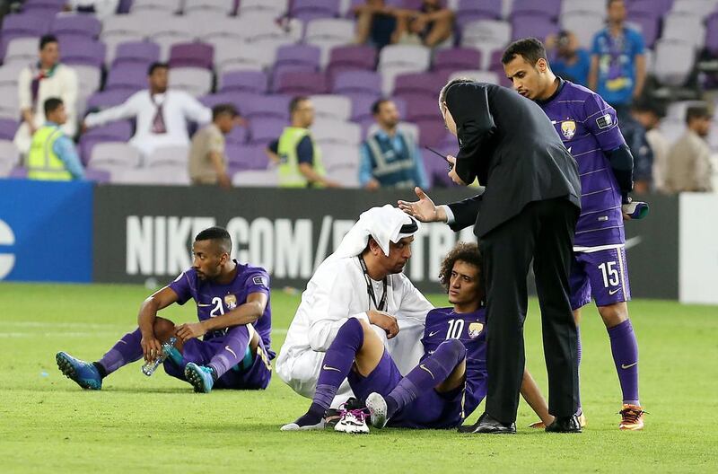 Al Ain captain Omar Abdulrahman, No 10, is consoled after the Asian Champions League final defeat. Pawan Singh / The National