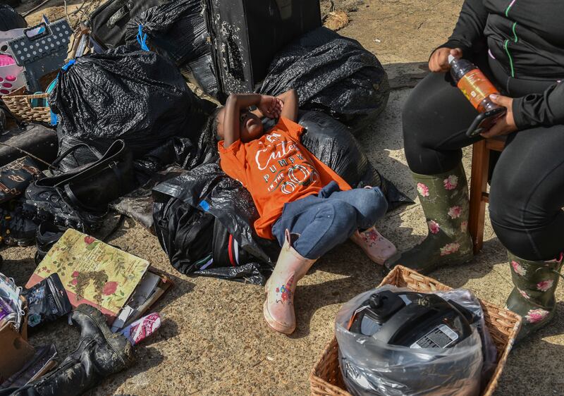 A survivor with his belongings after the deadly storms.  AP