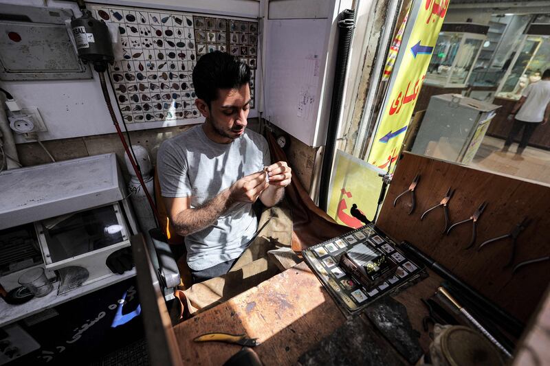 Iranian jeweller Mohammad Bazmi makes a ring at his workshop in Tehran's Grand Bazaar.
