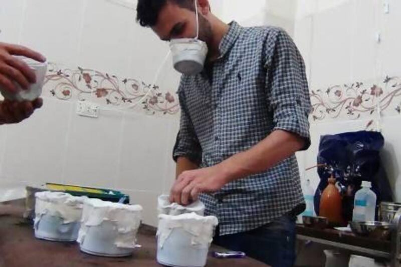 Activists and medics manufacture homemade chemical masks in the Damascus suburb of Zamalka following a poisonous gas attack that killed hundreds