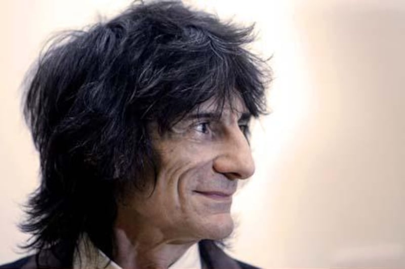 Rolling Stones British guitarist Ronnie Wood poses in front of his painting called 'A Study of Carlos and Darcey Rehearsing' which has been put display at the Royal Academy of Arts in London on February 27, 2008. AFP PHOTO/SHAUN CURRY