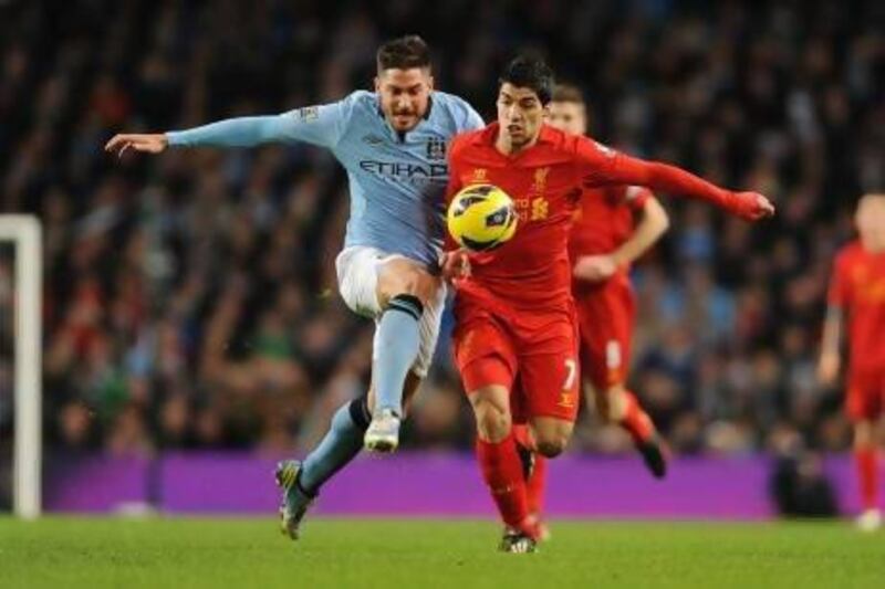 epa03566877 Liverpool's Luis Suarez ( r ) vies for the ball with Manchester City's Javi Garcia ( l ) during English Premier League soccer match Manchester City vs Liverpool at Etihad Stadium, Manchester, Britain, 03 February 2013. EPA/PETER POWELL DataCo terms and conditions apply. http://www.epa.eu/downloads/DataCo-TCs.pdf *** Local Caption *** 03566877.jpg