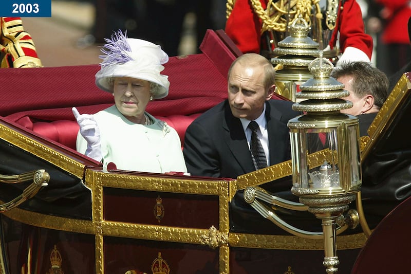 2003: Russian President Vladimir Putin is accompanied by the queen during a procession at the start of his state visit in London.