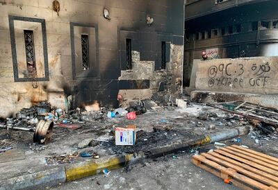 A protester checks the site of a gunmen attack in Baghdad, Iraq, Saturday, Dec. 7, 2019. Gunmen in cars opened fire Friday in Baghdad's Khilani square, killing and wounding scores of people. (AP Photo/Ali Abdul Hassan)