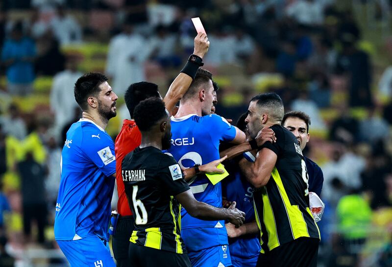 Al Hilal and Al Ittihad players scuffle after Ittihad's Abderrazak Hamdallah is shown a red card. Reuters