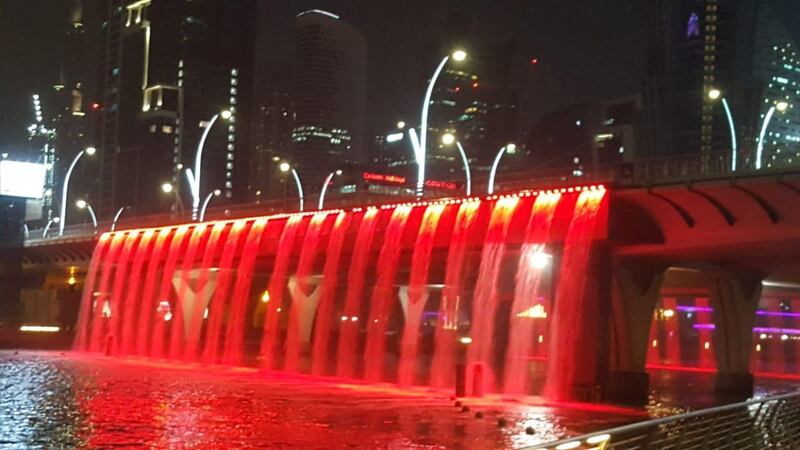 Dubai Water Canal lights up in red. The National