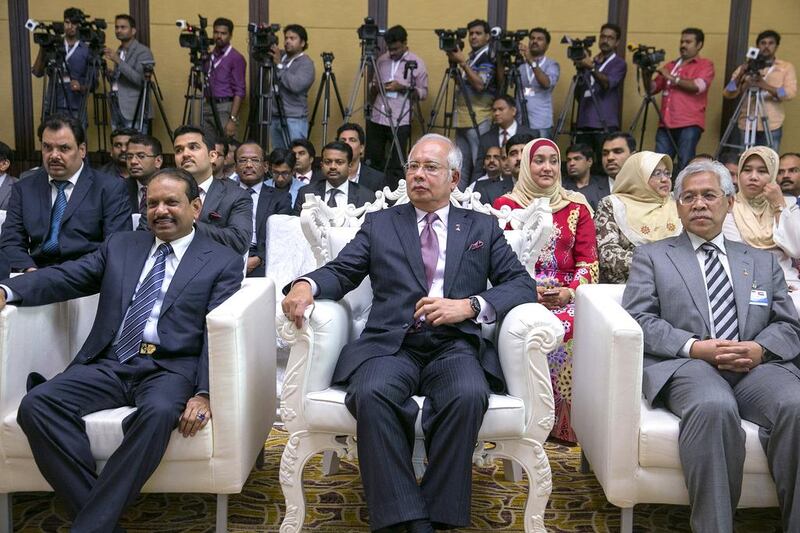 Yusuffali MA, the managing director of Lulu Group International, left, with the Malaysian prime minister Najib Razak, centre, during the signing of the memorandum of understanding. Silvia Razgova / The National