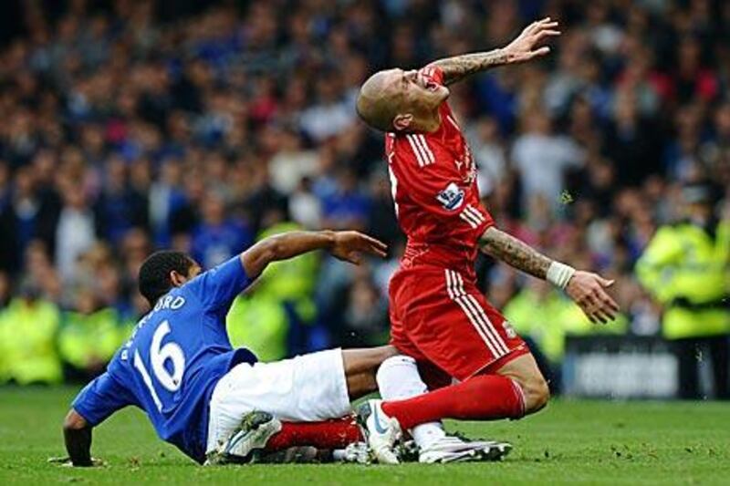 Jermaine Beckford, right, the Everton substitute, scythes down Martin Skrtel, the Liverpool defender.