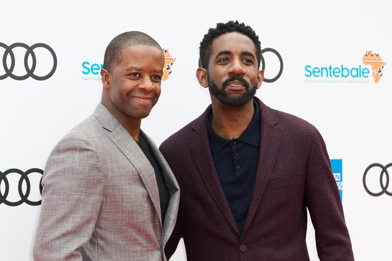 British actor Adrian Lester (L) and guest, poses on the red carpet. EPA