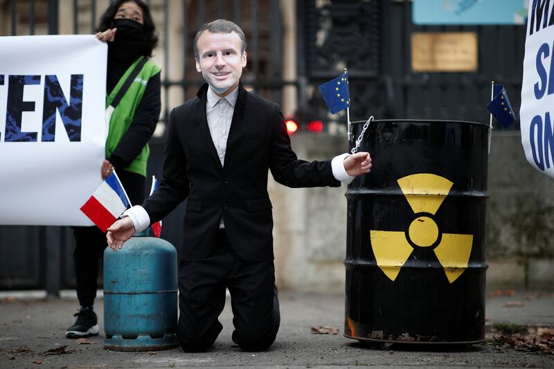 An activist dressed as French President Emmanuel Macron denounces Paris's push to include nuclear energy on an EU green list. Photo: Reuters