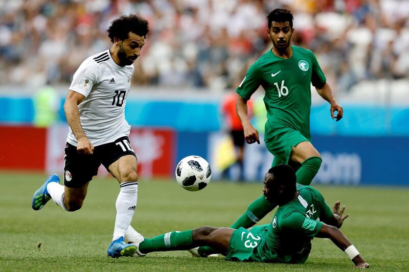 VOLGOGRAD, RUSSIA - JUNE 25 : Mohamed Salah (L) of Egypt in action against Motaz Hawsawi (R) of Saudi Arabia during the 2018 FIFA World Cup Russia Group A match between Saudi Arabia and Egypt at the Volgograd ArenaÂ in Volgograd, Russia on June 25, 2018. (Photo by Gokhan Balci/Anadolu Agency/Getty Images)