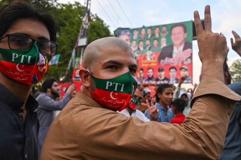 Supporters of Imran Khan's Pakistan Tehreek-e-Insaf party celebrate after the Supreme Court declared his arrest unlawful.  AFP