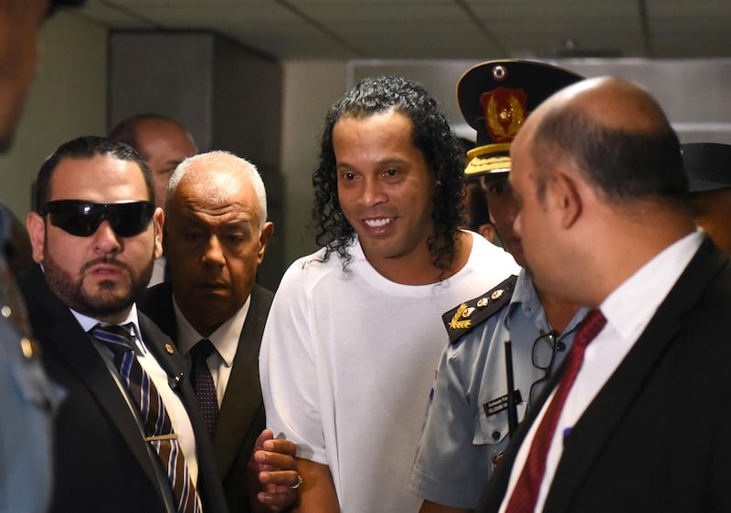 Former Brazil forward Ronaldinho arrives at Asuncion's Justice Palace to testify about his irregular entry to the country, in Asuncion, on March 6, 2020. AFP